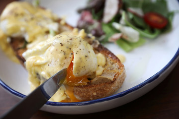 Egg benedict , poached eggs with toast on wood background , English Breakfast