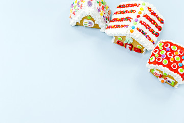 Gingerbread houses on the blue background. Christmas kids treats concept
