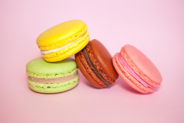 Fototapeta na wymiar Colorful Macaroon biscuits on pastel pink background