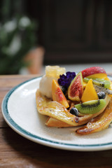 Dessert baked Waffle with fruits kiwo grape berry and vanilla ice cream vintage style