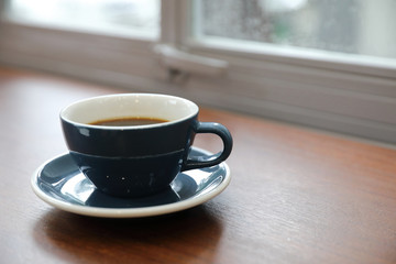 Black coffee in Coffee cup on wood background