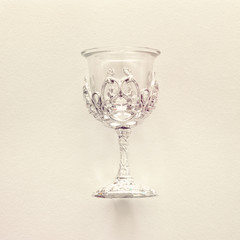 Top view image of jewish silver wine cup for wine. passover holiday and shabbat concept. Vintage filtered.