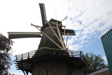 Old dutch windmill in village named Oldebroek with name De Hoop, still working as peel and as grind...