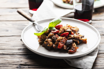Traditional sicilan eggplant dish caponata on the wooden table, selective focus