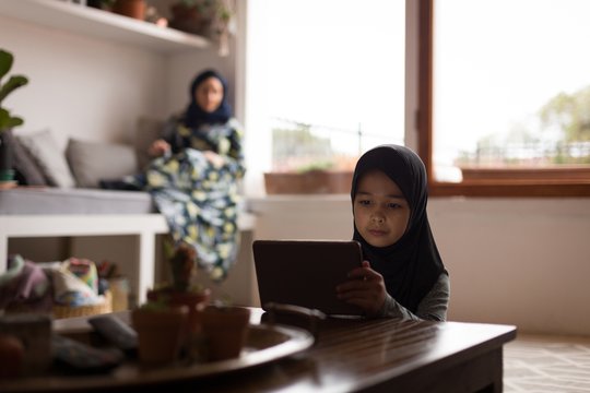 Muslim girl using digital tablet