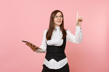 Young business woman holding tablet pc computer, touch something like push on button, pointing at...
