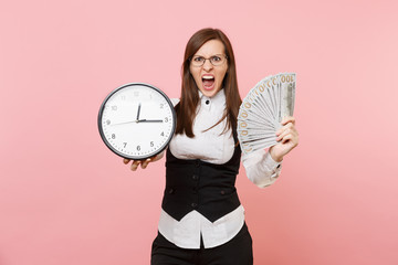 Young irritated business woman in glasses scream hold bundle lots of dollars cash money and alarm...