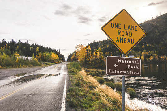 Chitina lake next to McCarthy road, Alaska. Reed, mountains and beautiful clean lake. Sign One lane road ahead.