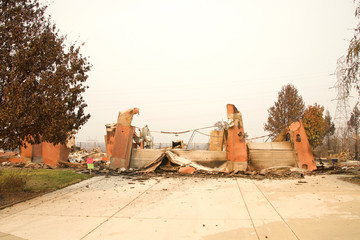 home burned to the ground, garage door buckled and laying in a heap after the recent wild fire fire...
