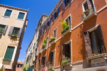 Architecture of narrow street of Venice at sunny day, Italy