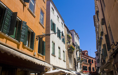 Fototapeta na wymiar Architecture of narrow street of Venice at sunny day, Italy