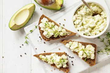 Avocado sandwiches. Traditional latinamerican mexican sauce guacamole. Healthy fat, omega 3. Top view flat lay background, copy space.