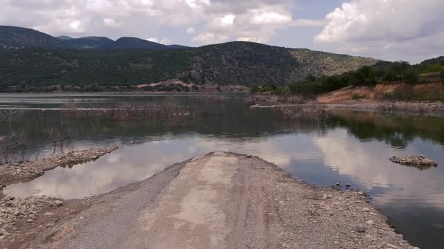 Old asphalt road submerged under the waters of Doğan&ouml;z&uuml; dam in Kızılcahamam. Ankara in Turkey