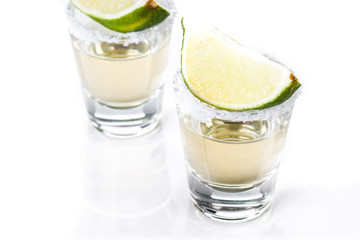 Mexican Gold tequila with lime and salt isolated on white background


