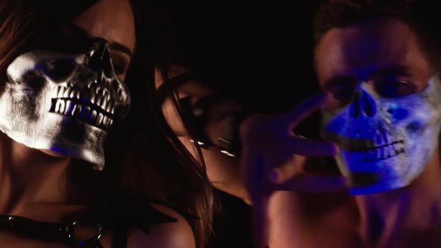 Man and woman dancing in skull masks