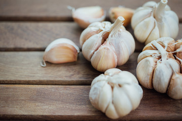 Garlic and cloves on wooden background