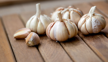 Garlic and cloves  on wooden background