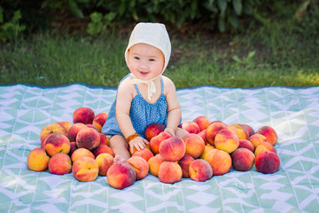 Baby Girl Sitting With Fresh Peaches