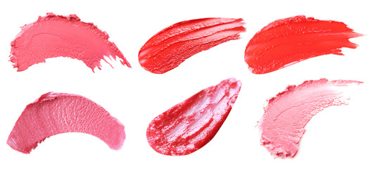 Makeup product smears on white background. Color set of lip glosses and lipsticks