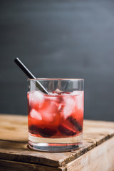 Old fashioned cocktail with cherry. Selective focus.