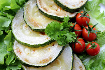fried zucchini with cherry tomatoes lying on a plate