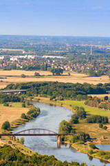 Fototapeta na wymiar Bridge on the Weser river in Germany. A beautiful view from the monument of Prince Wilhelm in Porta Westfalica.