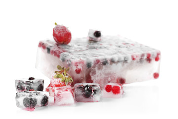 Fresh berries frozen in ice cubes on white background