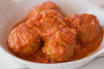 Some meat balls with tomatoes sauce.