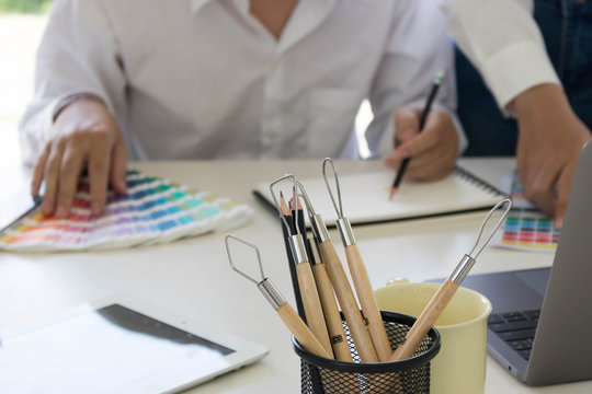 Team of creative designers working with tablet for new project in a design studio