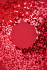 Star sprinkles on red with round space. - obrazy, fototapety, plakaty