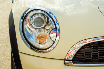 Car head light white beige in the street