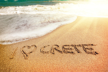 Crete inscription on the sand near the sea