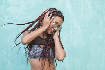 african american woman listening to a funky playlist on her phone