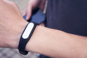 Fitness tracker on the man's hand, sports accessory fitness bracelet.