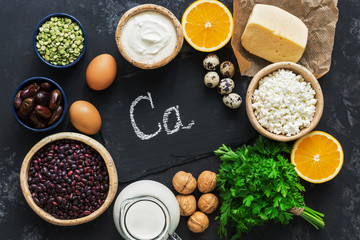 Food with calcium on a black concrete background. A set of products rich in calcium.Flat lay of the copy space.