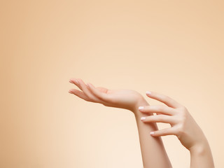 Closeup image of beautiful woman's hands with light pink manicure on the nails. Skin care for...