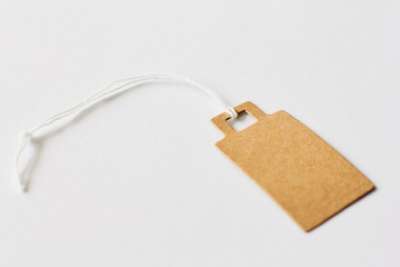 Blank brown cardboard price tag, sale tag, gift tag, address label on white background