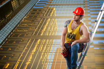 Construction, building and workers concept - Caucasian male builder wearing white helmet.