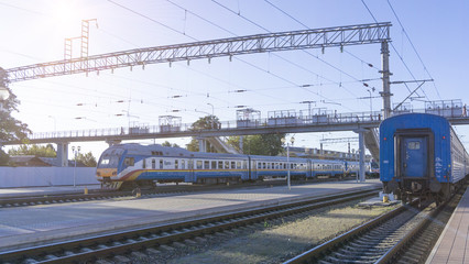 Obraz premium Power lines on the railway. Blue sky, sunlight. Railway