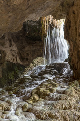 small waterfall falling over rocks in the Kaklik cave, Denizli, Turkey