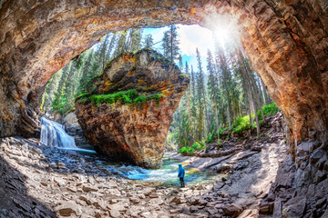 Hiker at Johnston Canyon Cave in Banff National Park Canada - obrazy, fototapety, plakaty