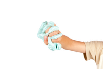 Young boy's hand squeezing a blue slime toy. Isolated on white background.