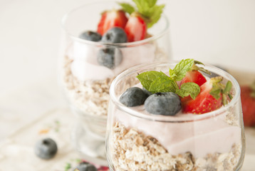 Healthy breakfast, close up oat meal with fruits: blueberry, strawberry and mint, rustic background. Healthy food. Isolated.