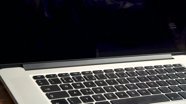 Cleaning dust on laptop notebook keyboard  with brush