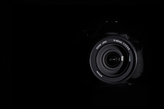 SLR camera lens on a black background