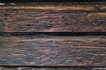 Weathered rustic wood plank background texture with yellow, black, and brown color tones