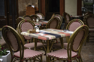 Beautiful view of the open terrace restaurant- cafe. Red texture chairs and colorful wood tables.