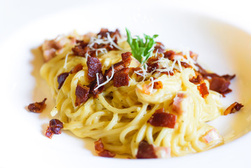 Close up Spaghetti Carbonara with bacon and cheese in white plate