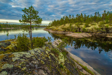 Fototapeta na wymiar Karelia. Rocky shore. Ladoga lake. The Republic of Karelia. Russia. Islands in the Ladoga. Morning in the Ladoga.