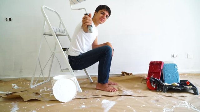 Painting Equipment in the room and young men doing renovations